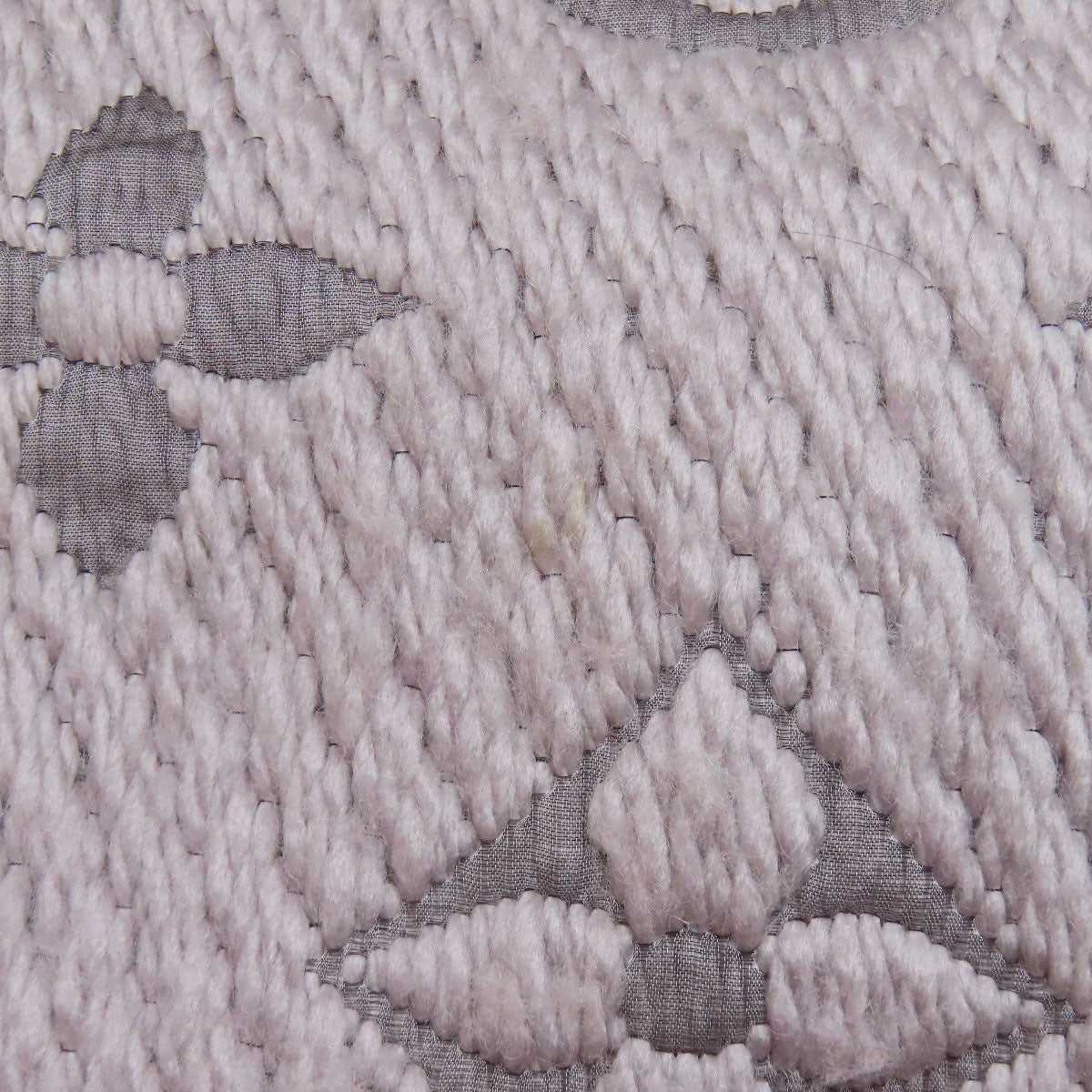 Close-up detail of a pre-owned Louis Vuitton wool scarf featuring the iconic monogram pattern