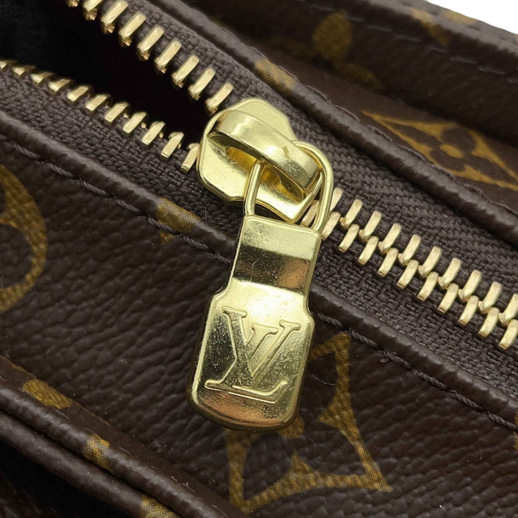 Close-up of MANSII Louis Vuitton bag zipper in brown, condition used like new