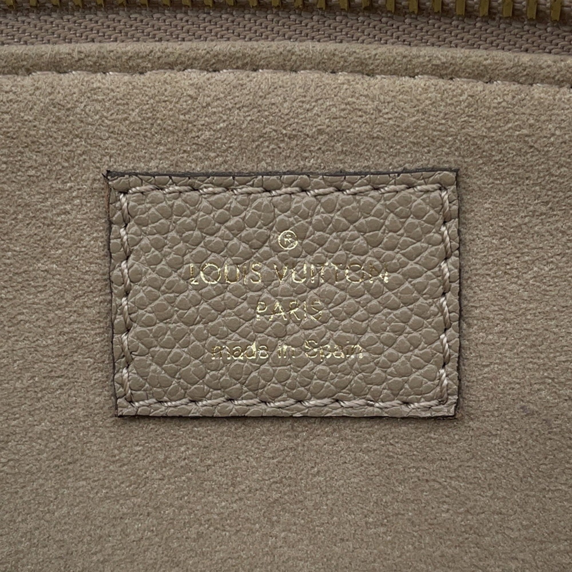 Interior label of LOUIS VUITTON used Petit Palais PM handbag showing brand details and craftsmanship