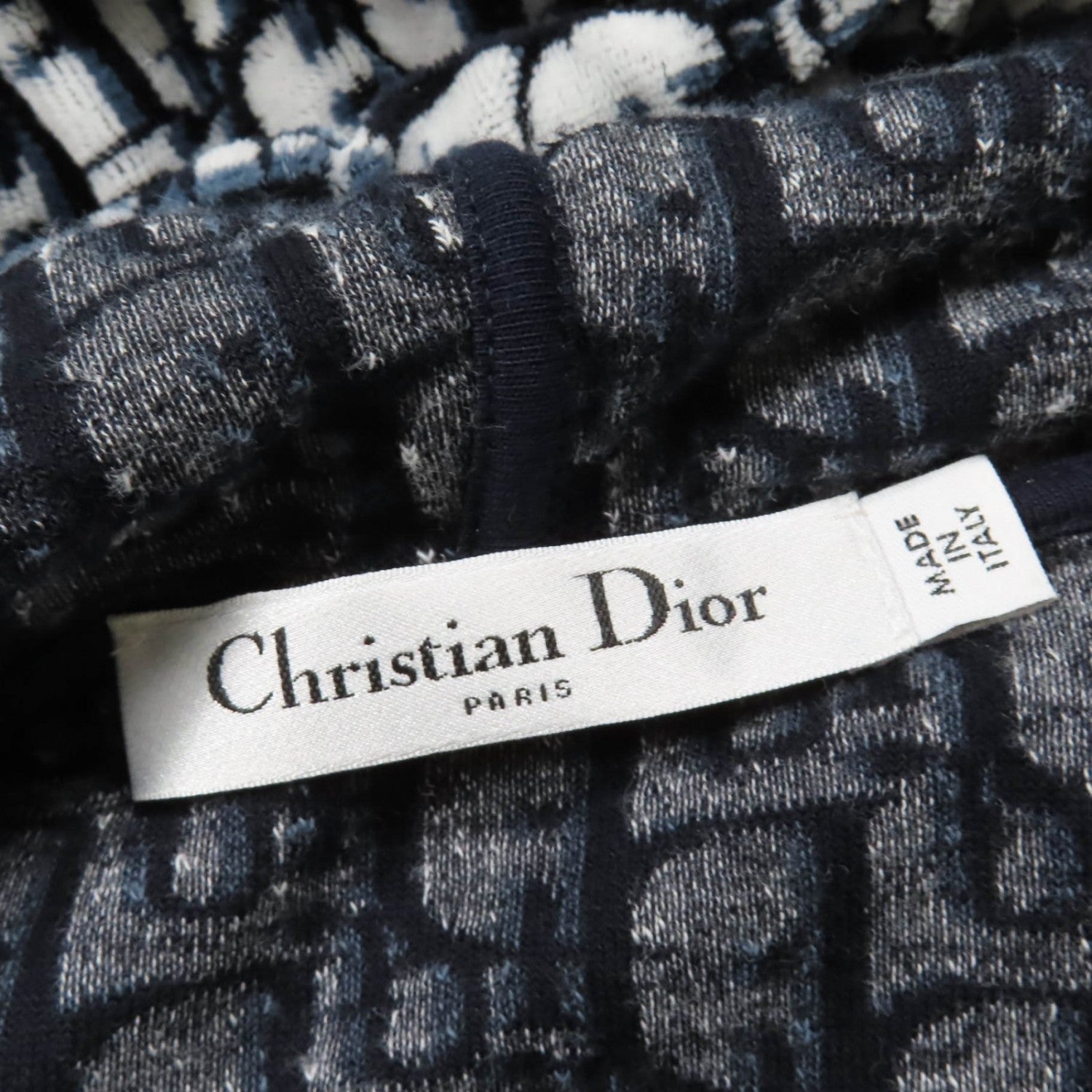 Close-up of a Christian Dior label showcasing luxury secondhand Dior womenswear for sophisticated style