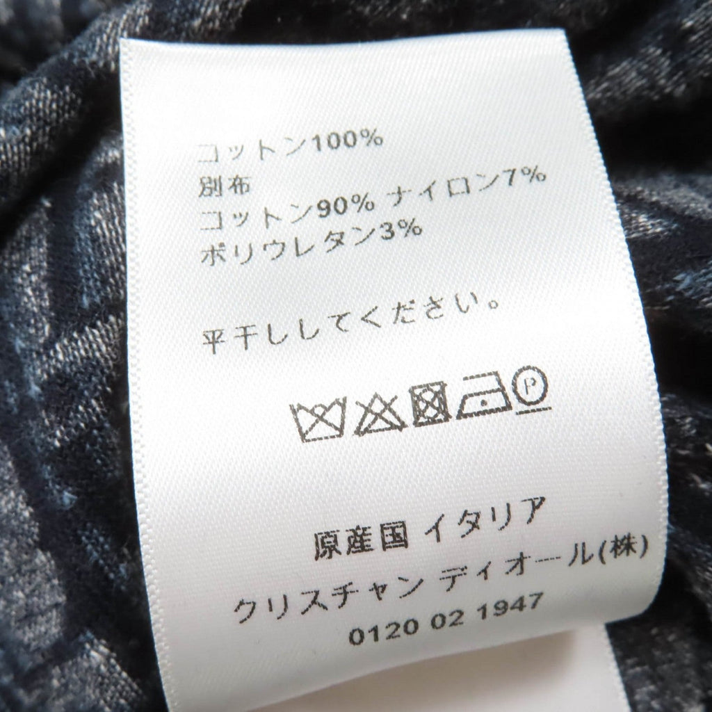 Care label on luxury secondhand Dior womenswear displaying fabric composition and washing instructions