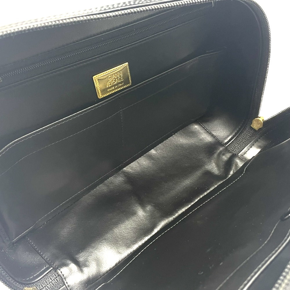 Interior view of a luxury vintage Versace purse featuring multiple compartments and a sleek black finish