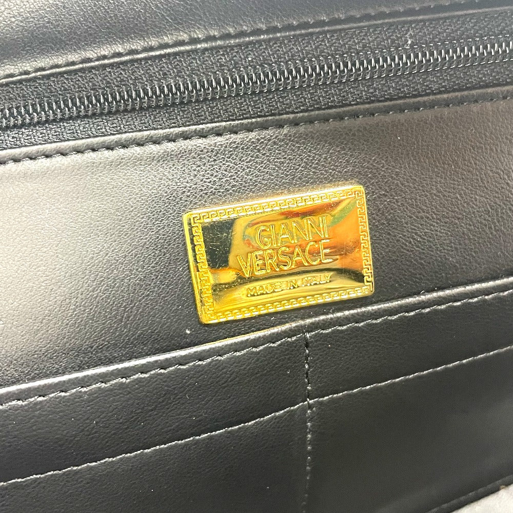 Interior tag of a luxury vintage Versace purse showcasing the Gianni Versace brand logo