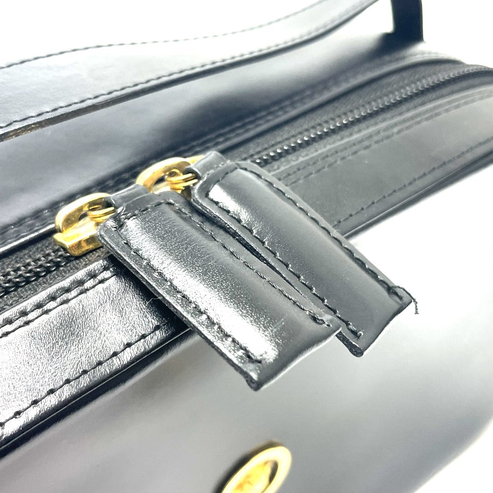 Close-up of luxury vintage Versace purse featuring a high-quality zipper and sleek black leather design