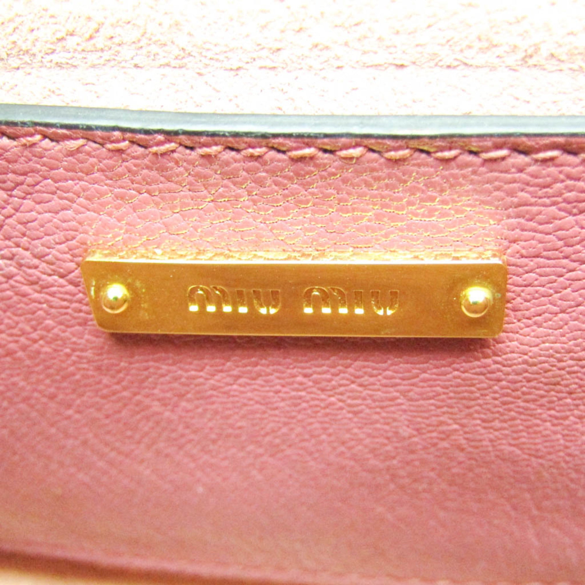 Close-up of MIU MIU Pre-Loved MADRAS shoulder bag's gold logo plate on pink textured leather