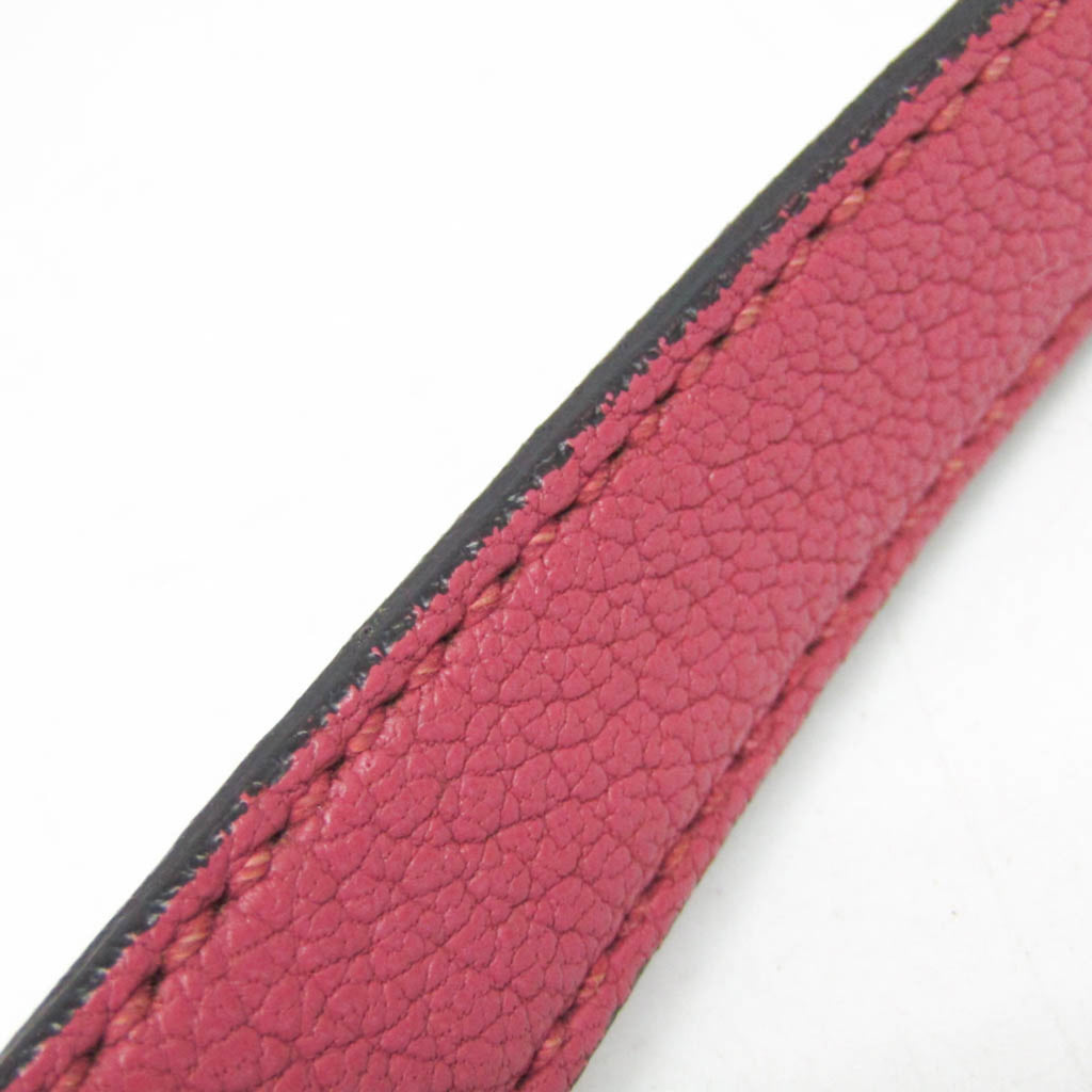 Close-up of the strap detail on the MIU MIU Pre-Loved MADRAS shoulder bag in vibrant pink leather