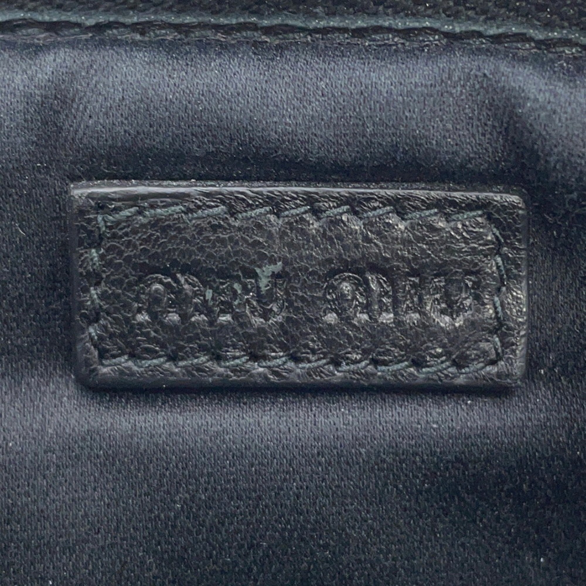 Close-up of MIU MIU Pre-Loved Swallow Pattern Bag logo embossed on leather for authenticity