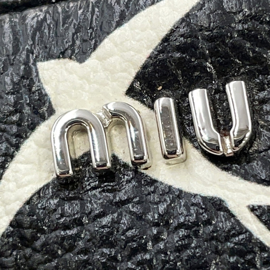Close-up of MANSII MIU MIU Pre-Loved Swallow Pattern Bag logo in shiny silver metal on textured leather