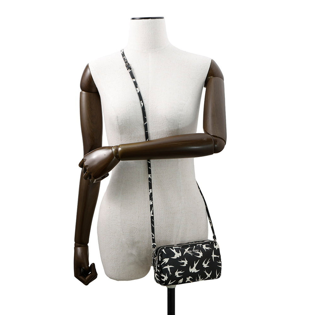 MANSII MIU MIU Pre-Loved Swallow Pattern Bag displayed on a mannequin with a crossbody strap