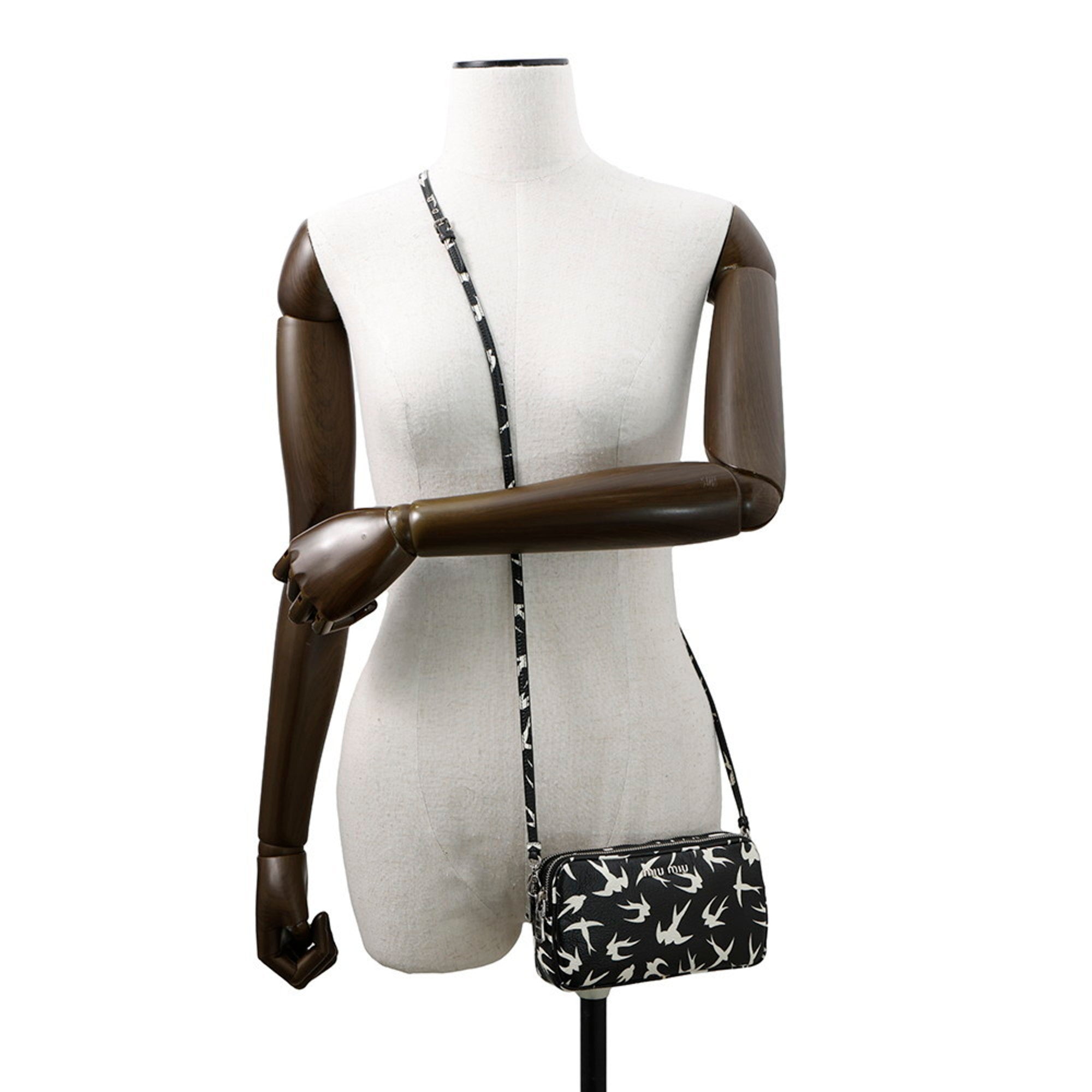 MANSII MIU MIU Pre-Loved Swallow Pattern Bag displayed on a mannequin with a crossbody strap