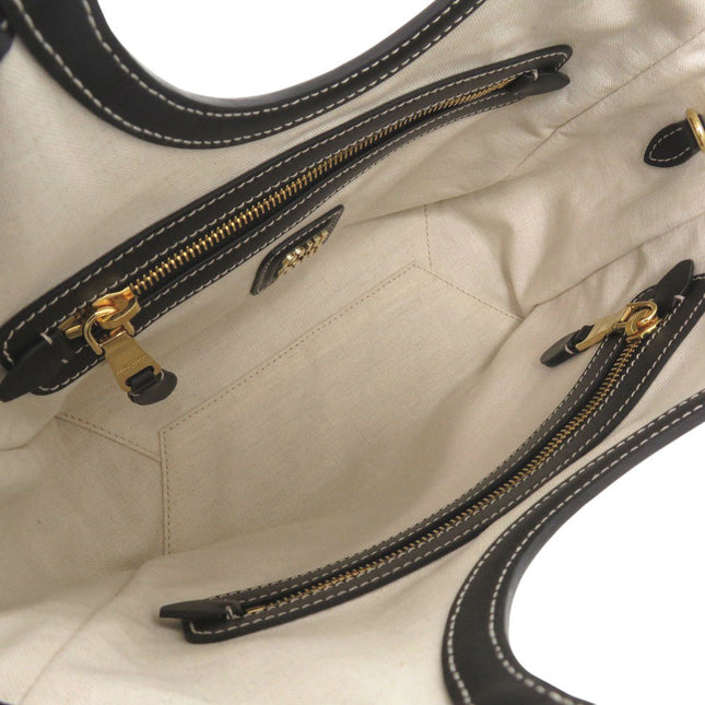 Interior of MIU MIU pre-owned bag featuring multiple zip pockets and a spacious design