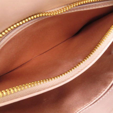 Interior of a MIU MIU pre-owned bag showing a spacious compartment with gold zipper detail
