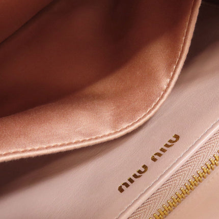 Interior view of a MIU MIU pre-owned bag featuring soft lining and gold branding