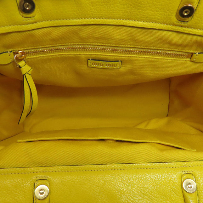 Interior of a MIUMIU yellow bag showing spacious compartment and pre-owned condition