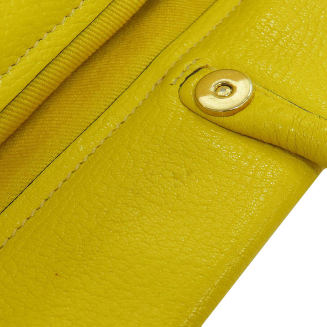 MIUMIU pre-owned yellow leather bag with a secure snap closure and textured finish