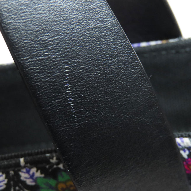 Close-up of MIU MIU Pre-Owned bag showcasing the leather straps with slight wear