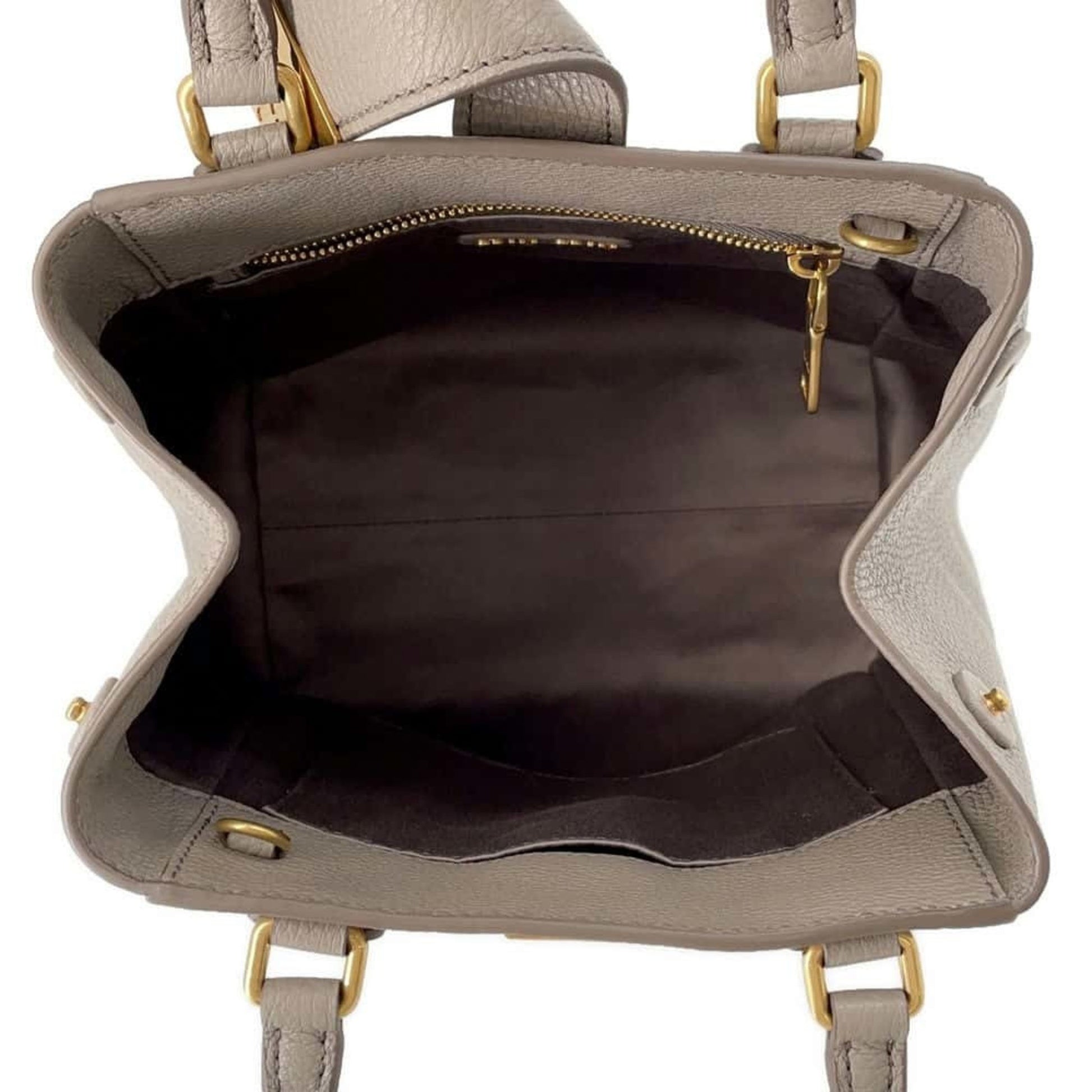 Inside view of a Miu Miu pre-owned bag showing spacious compartments and elegant design