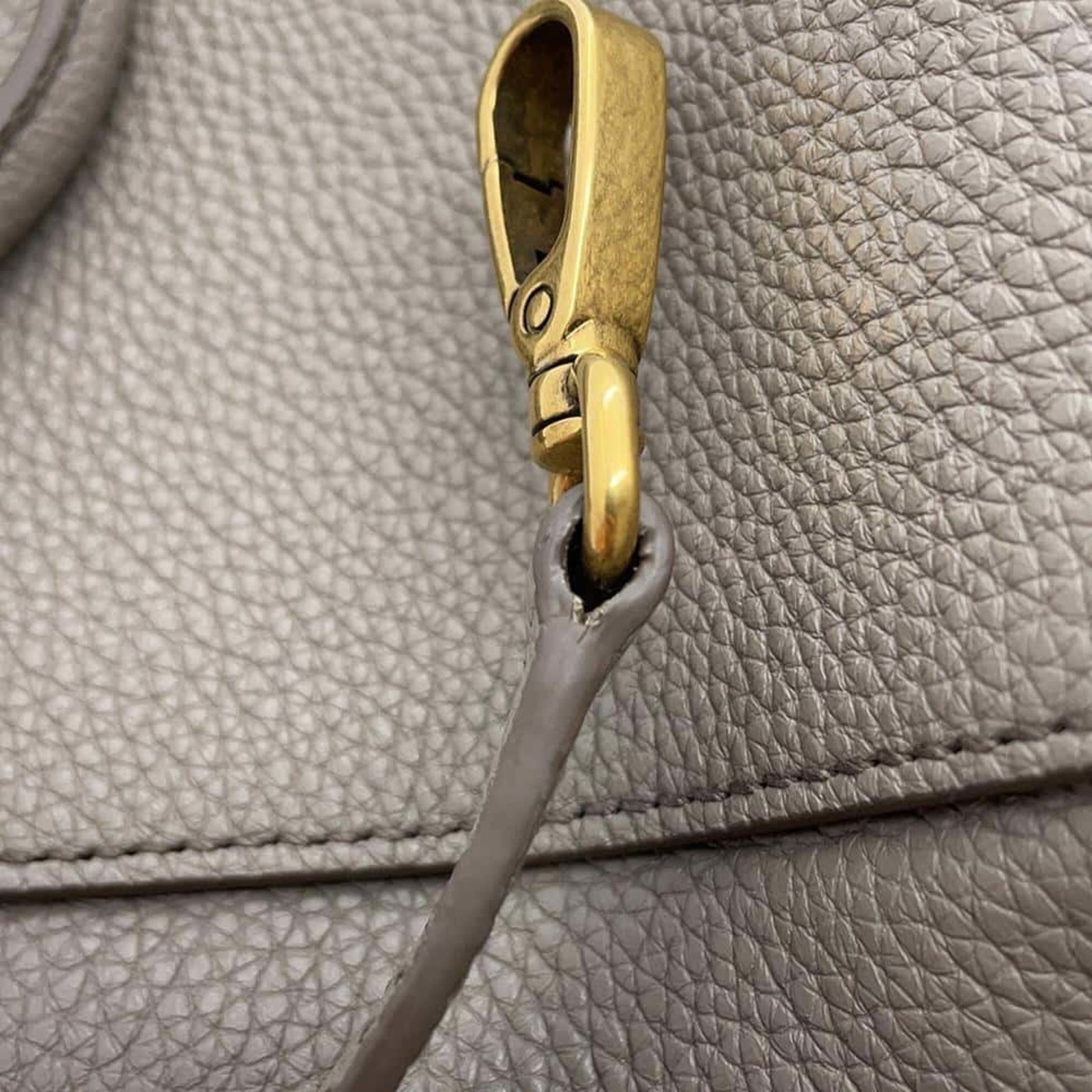 Miu Miu pre-owned bag showing detailed metal clasp and textured leather material