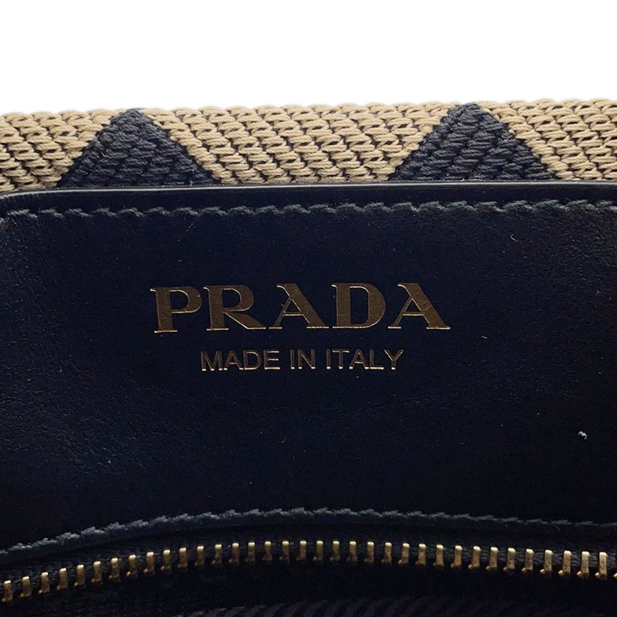 MANSII Prada bag interior featuring gold logo with woven design for a stylish mob wife look