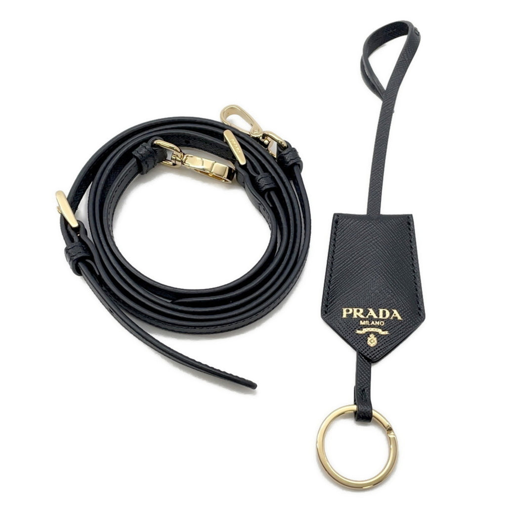 Prada black leather strap with gold hardware, ideal for a chic mob wife look