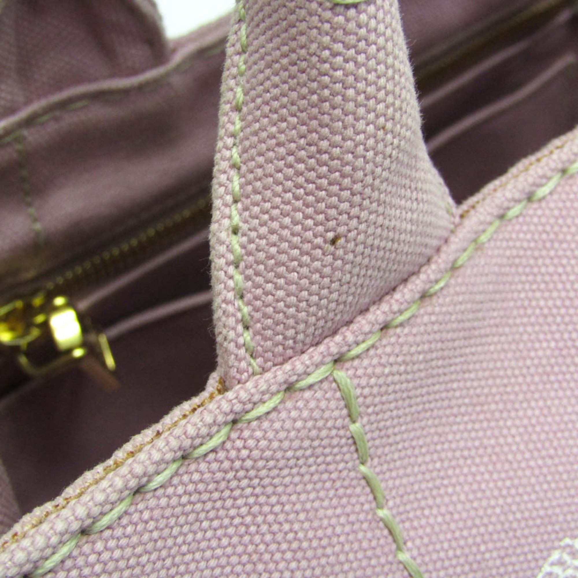 Detail of PRADA Pre-Loved Canapa bag showcasing elegant stitching and soft fabric texture