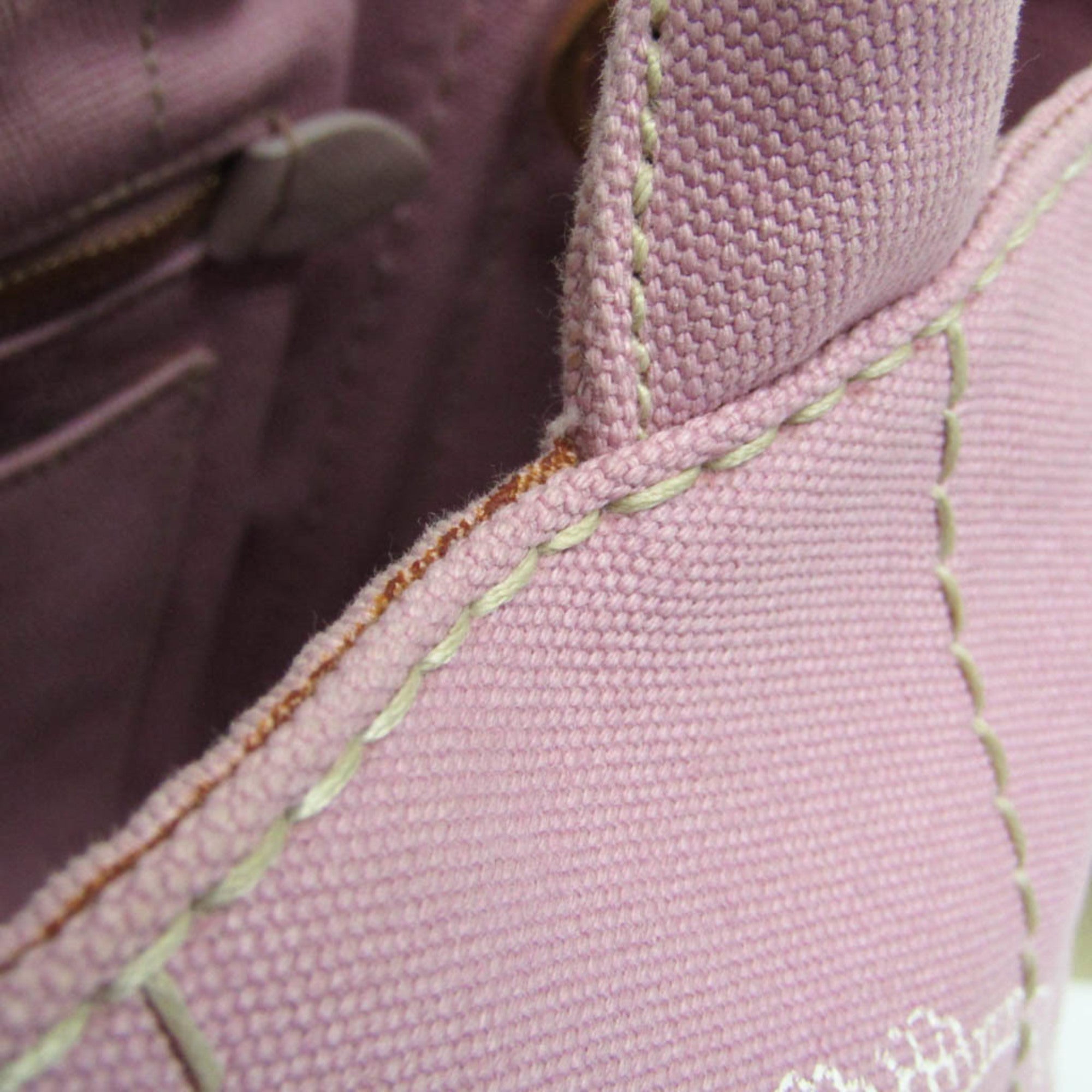 Close-up of the interior stitching of a PRADA Pre-Loved Canapa bag in soft pink fabric