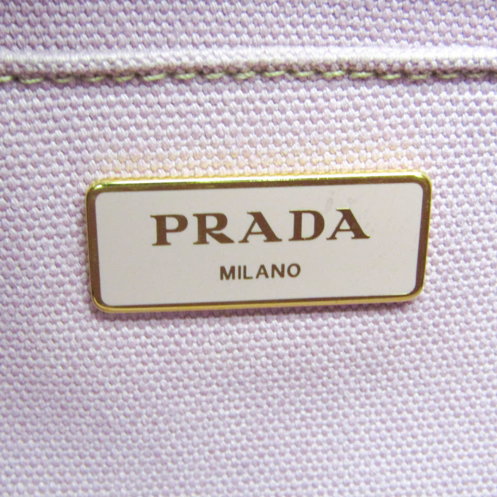 Close-up of PRADA Pre-Loved Canapa bag showing the signature PRADA MILANO label in gold detailing