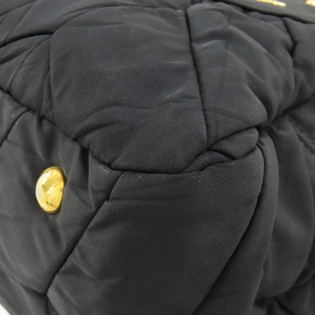 PRADA pre-owned quilted black bag featuring gold accents and a soft texture