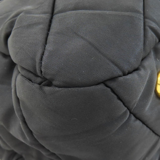 PRADA pre-owned black quilted bag showcasing textured fabric and logo detail