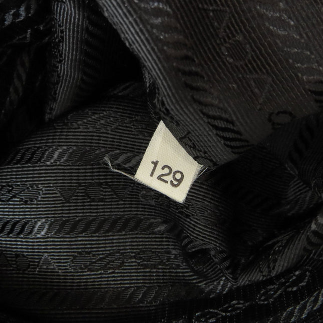 PRADA pre-owned bag interior showing black satin lining and tag details