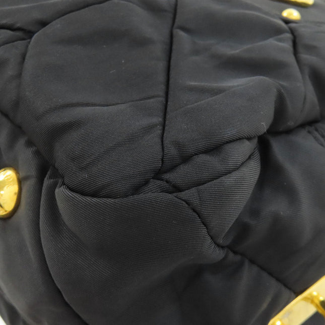 PRADA pre-owned black quilted bag with gold accents and unique texture