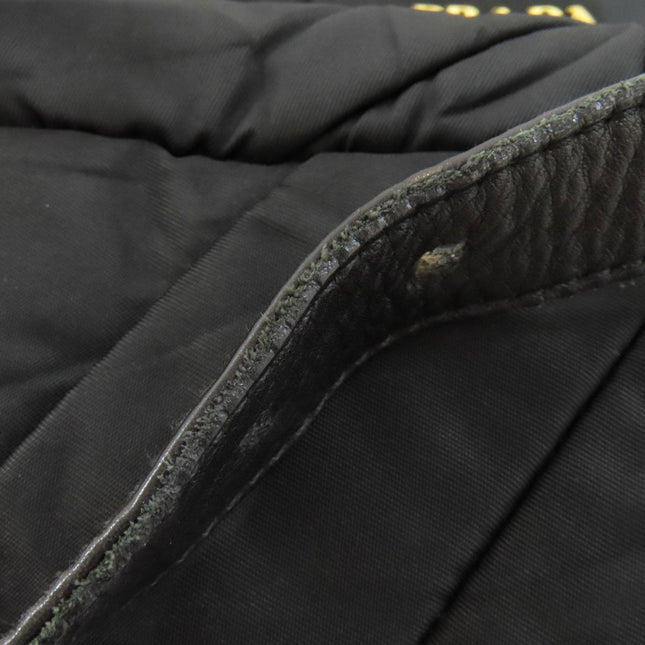 PRADA pre-owned quilted black bag featuring textured leather detailing and gold logo accents