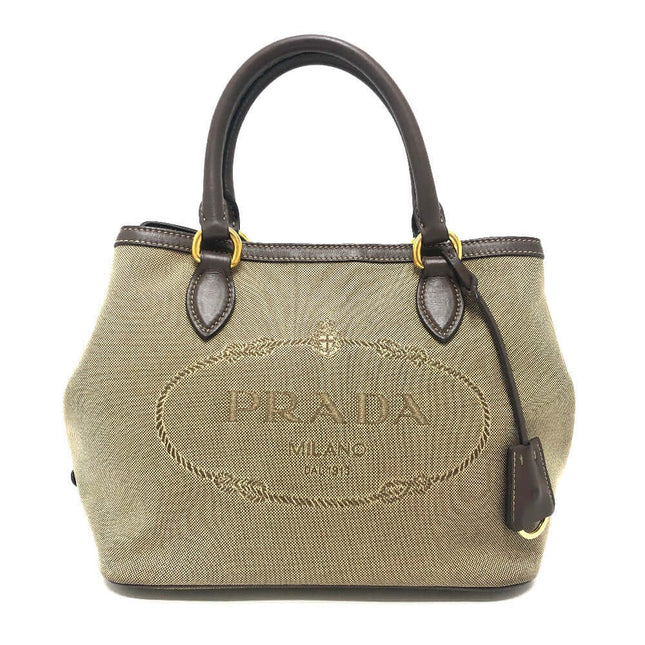 Pre-owned PRADA tote bag in beige with embossed logo and brown leather accents