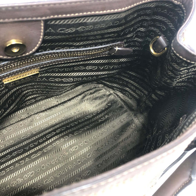 Interior view of a PRADA pre-owned bag showing the iconic logo lining and pockets