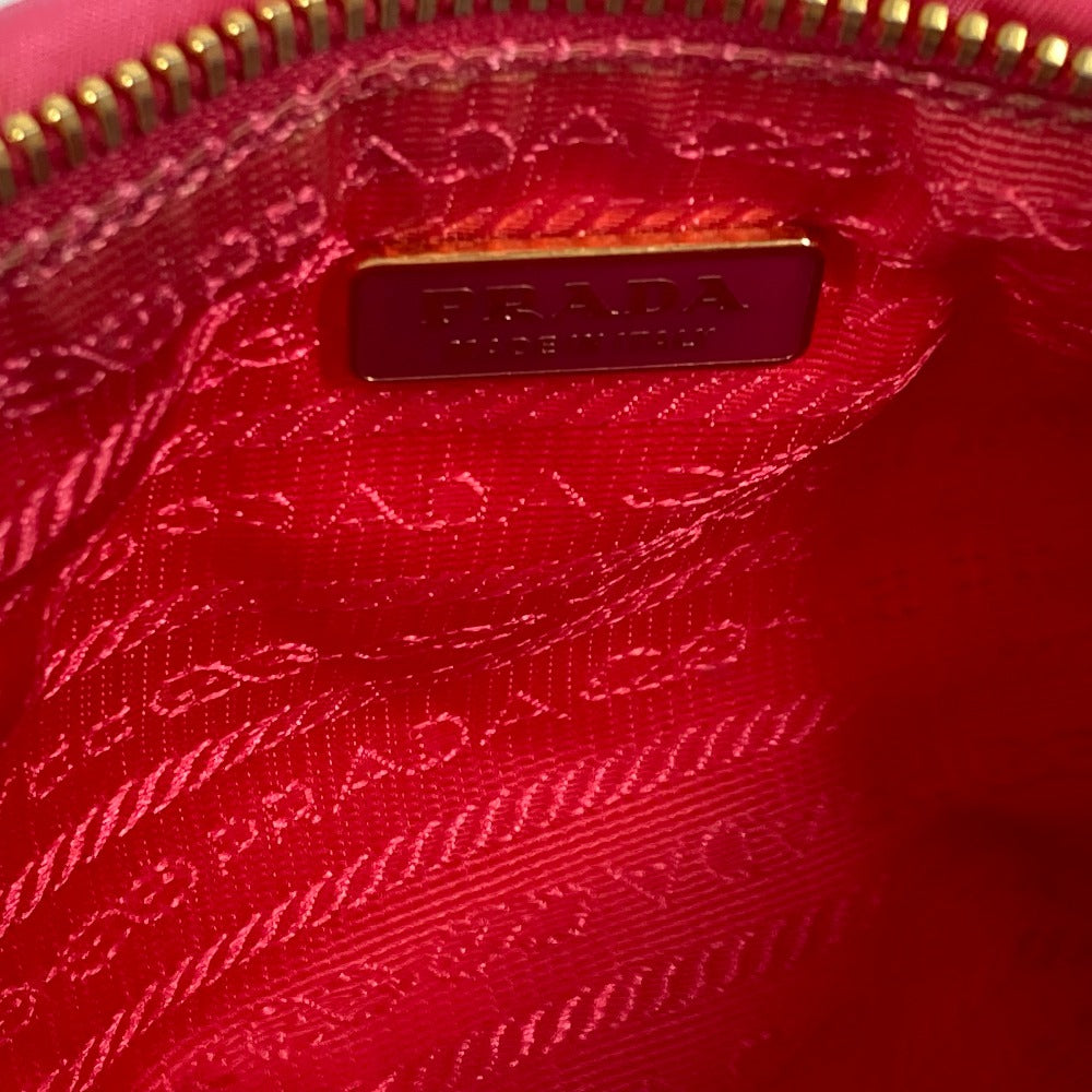 Interior view of PRADA vintage bag showcasing vibrant pink lining and branded logo detail