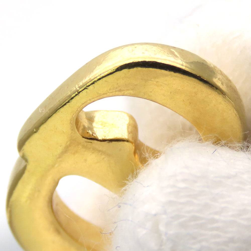 Close-up of a pre-loved Christian Dior gold ring with unique design features and polished finish