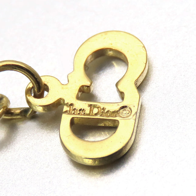 Close-up of a gold pre-loved Christian Dior charm showcasing intricate detailing and logo
