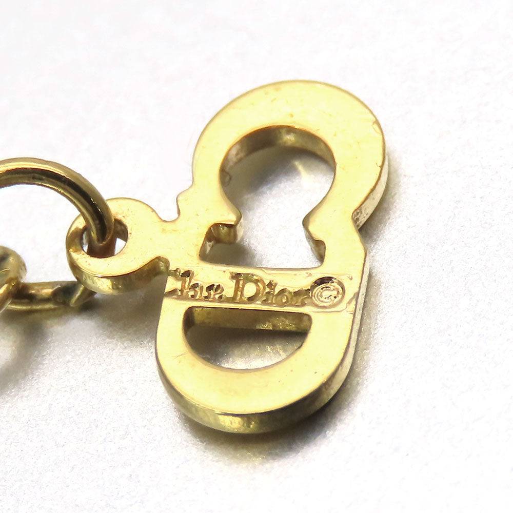 Close-up of a gold pre-loved Christian Dior charm showcasing intricate detailing and logo