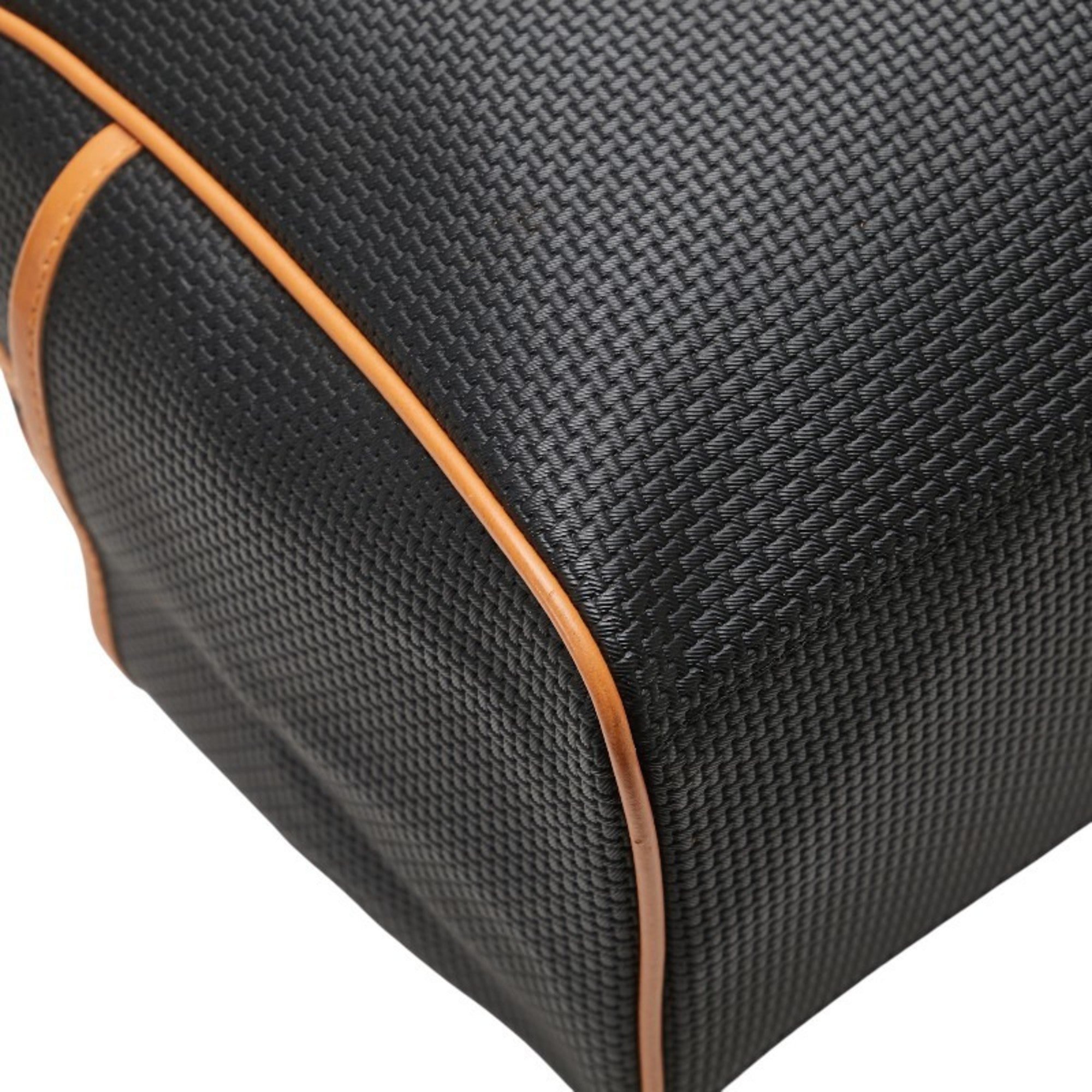 Close-up of the textured surface of a pre-loved Saint Laurent mini Boston bag with orange trim