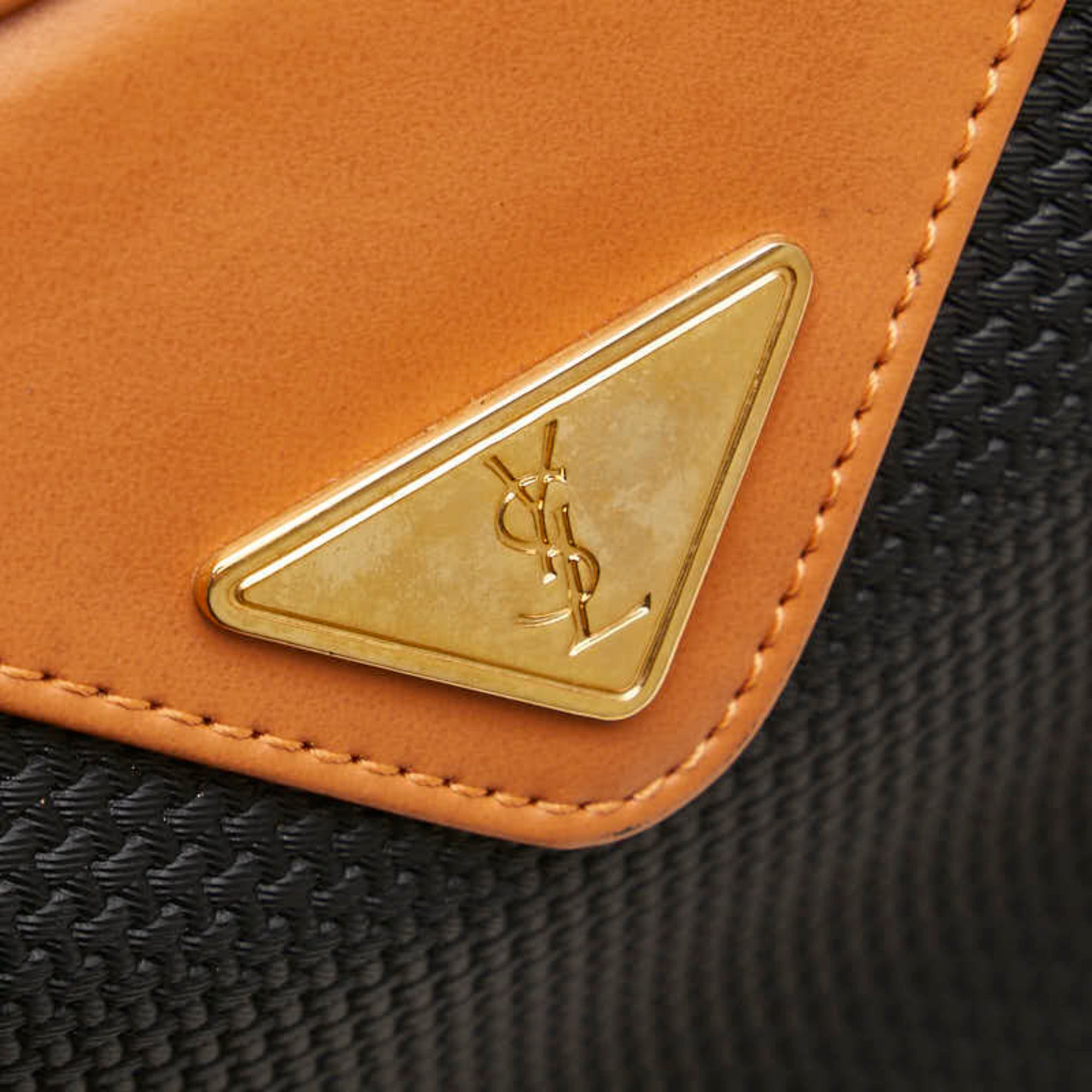 Close-up of gold YSL logo on a pre-loved Saint Laurent mini Boston bag's leather trim