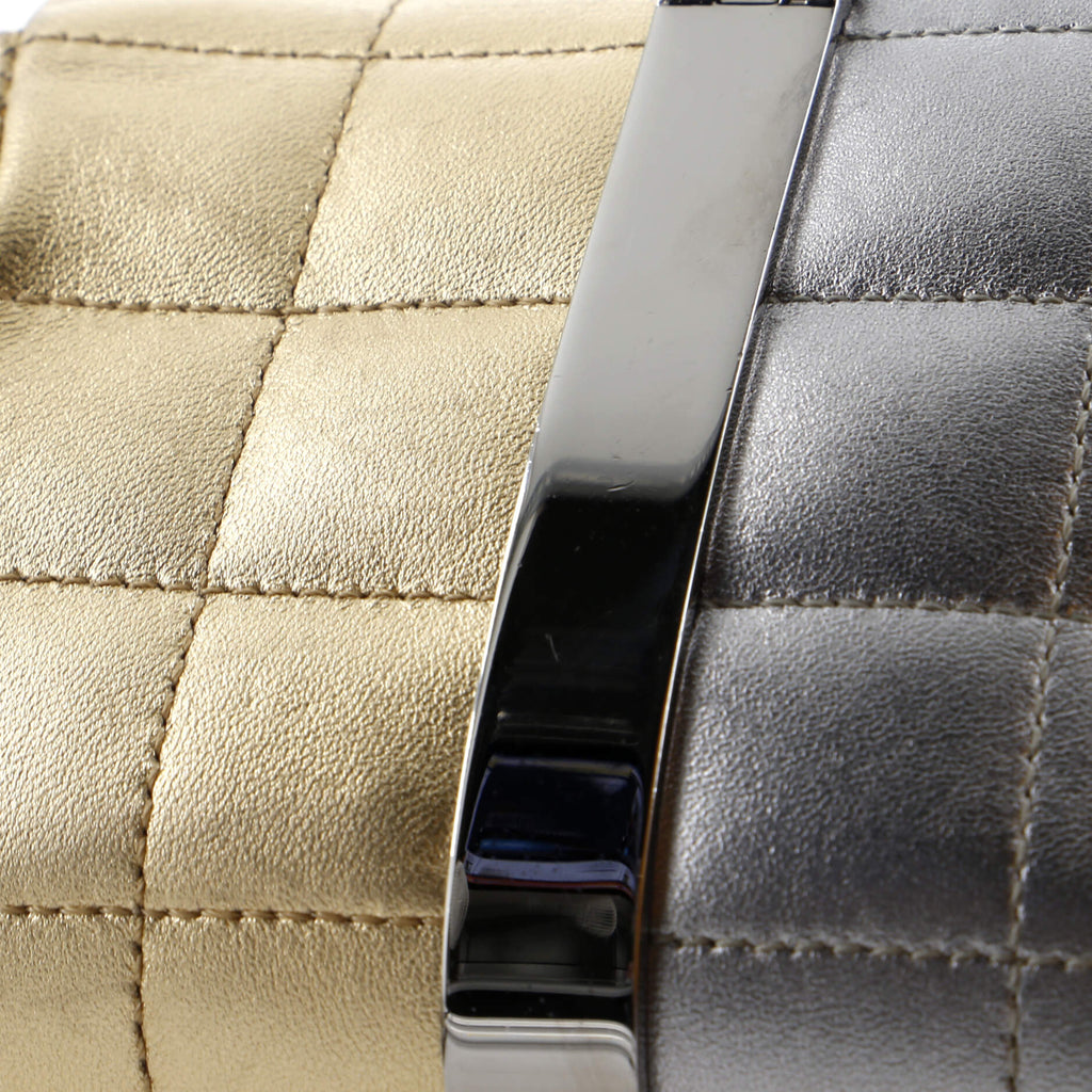 Close-up of pre-owned CHANEL wristlet bag with metallic gold and silver quilted texture