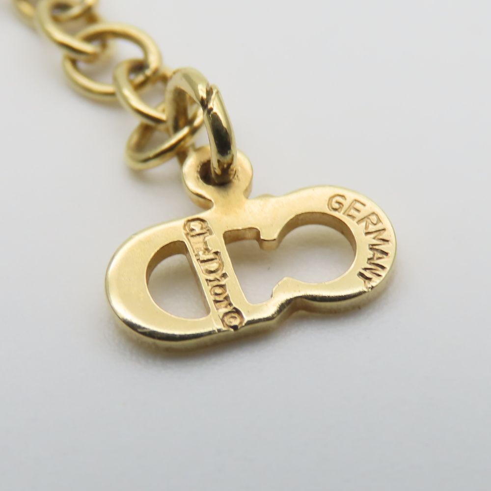 Close-up of pre-owned Christian Dior gold necklace with signature clasp detail