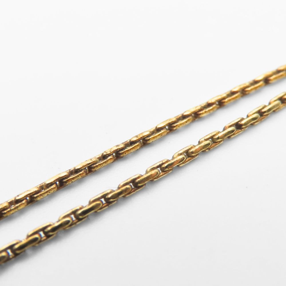 Close-up of pre-owned Christian Dior gold necklace featuring elegant links for a timeless look