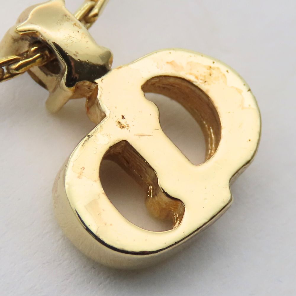 Close-up of a pre-owned Christian Dior gold necklace featuring an elegant design