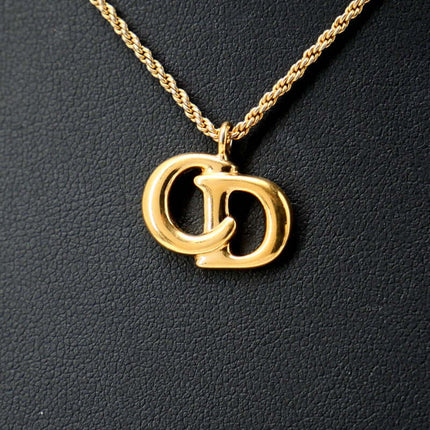 Christian Dior pre-owned gold necklace featuring iconic CD logo charm on a twisted chain
