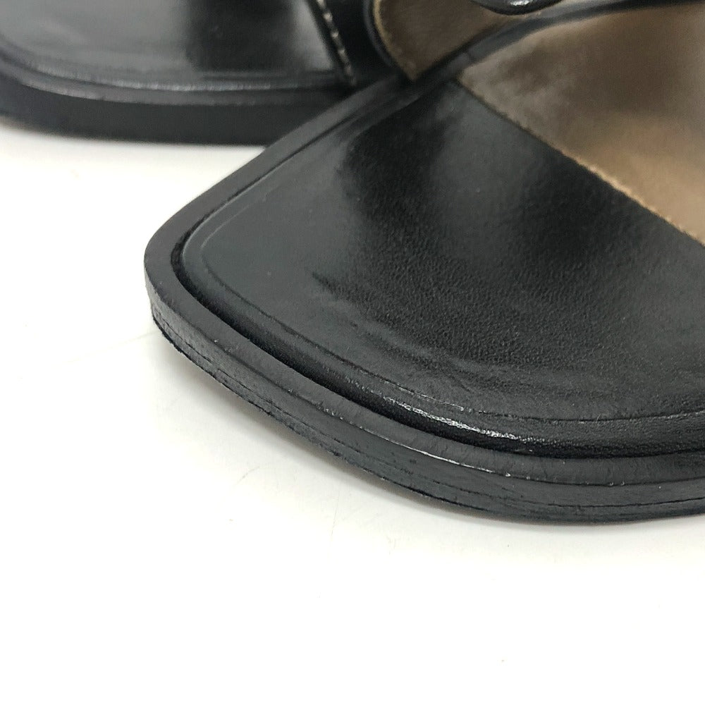 Close-up of pre-owned Hermes Oran sandals featuring a sleek black leather design