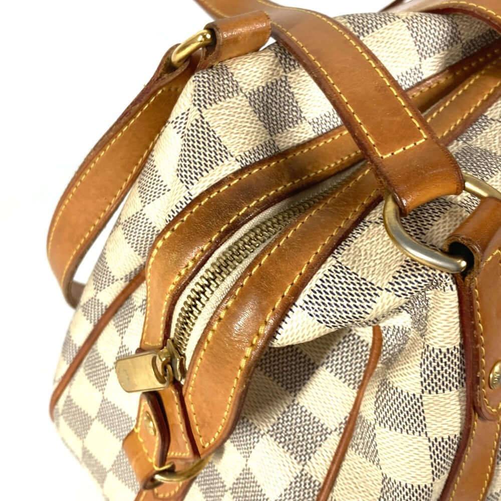 Louis Vuitton pre-owned bag with signature checkered pattern and leather accents