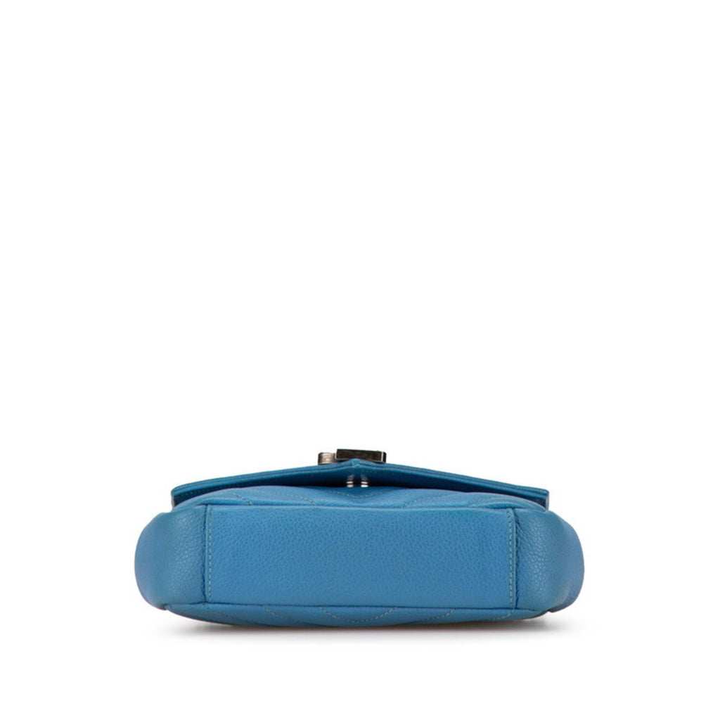 View of the base of a pre-owned Saint Laurent Baby Chai bag in blue leather with elegant design