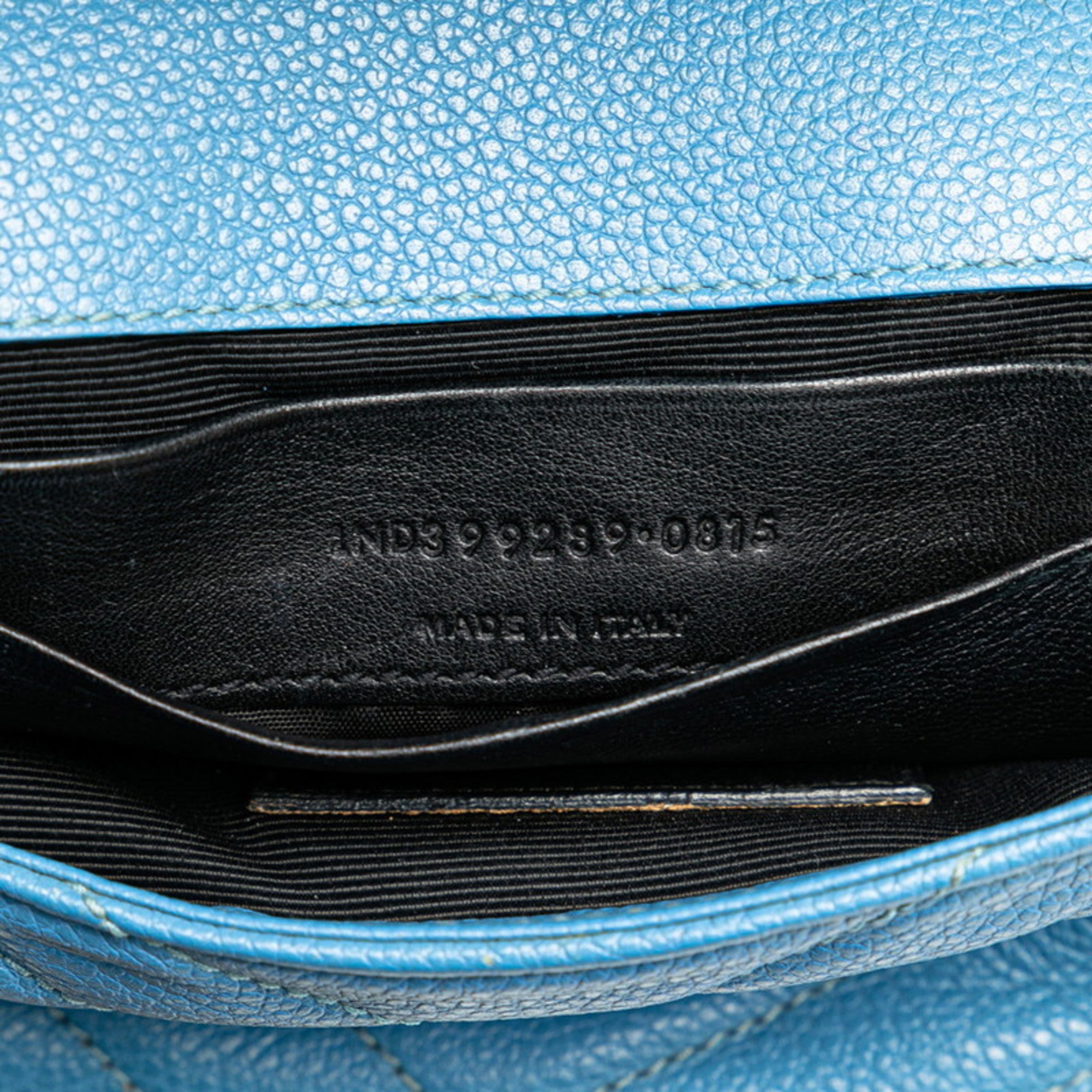 Interior view of pre-owned Saint Laurent Baby Chai bag featuring black leather lining and made in Italy tag