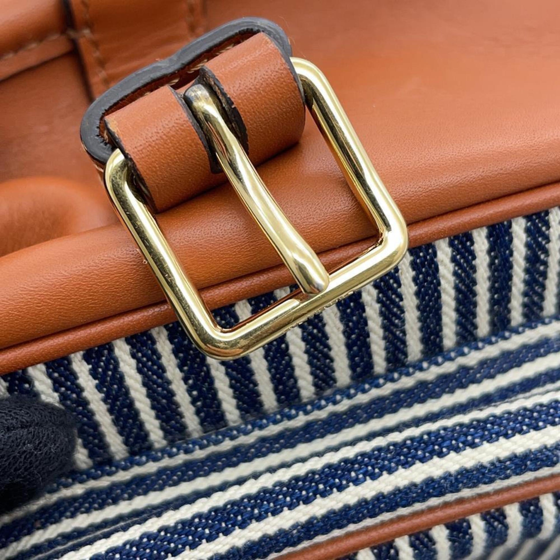 Celine Pre-Owned handbag detail featuring a gold buckle and striped fabric interior